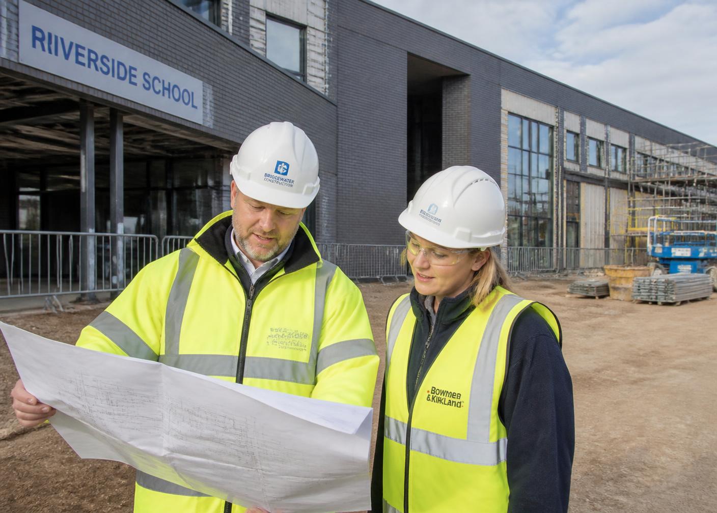 Contractors reviewing drawings on a public sector construction site
